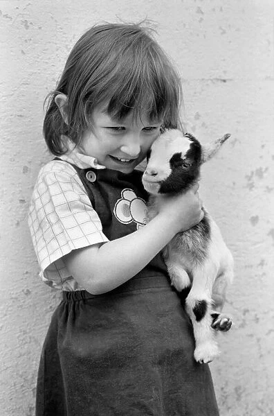 Child holding a baby goat in the farmyard section at Crystal Palace childrenOs Zoo