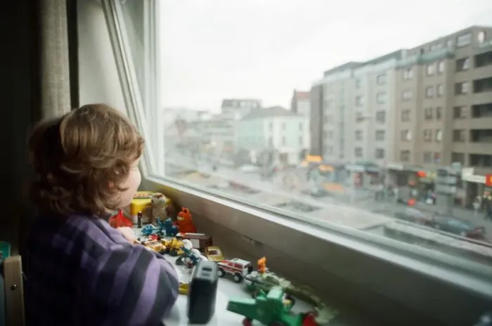 Framed Print : Child looks through window with view of Red light district in Hamburg, West Germany