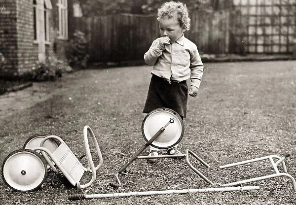 Child playing in the garden. Circa 1950