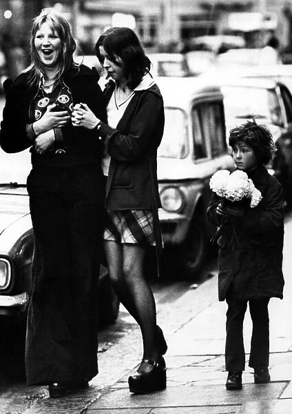 A child selling paper flowers on the streets of Newcastle on 27th December 1974