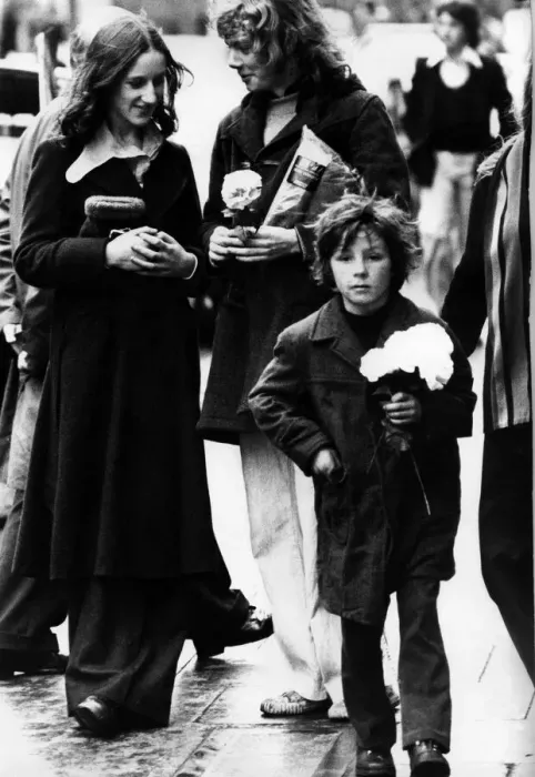 Framed Print : A child selling paper flowers on the streets of Newcastle on 27th December 1974 Framed Print : A child selling paper flowers on the streets of Newcastle on 27th December 1974