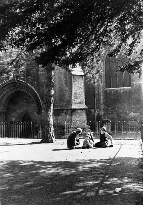 Framed Print : Childhood confidences in the playground of the girls school beside the walls of Tewesbury