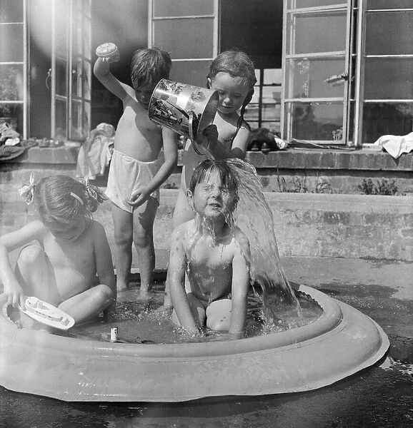 Children of Alexandra Day Nursery near Loch Lomond, Scotland cool off in a portable
