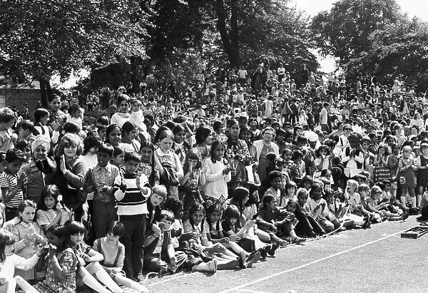 Children of all ages and backgrounds line the route of the 1973 Hillfields Carnival