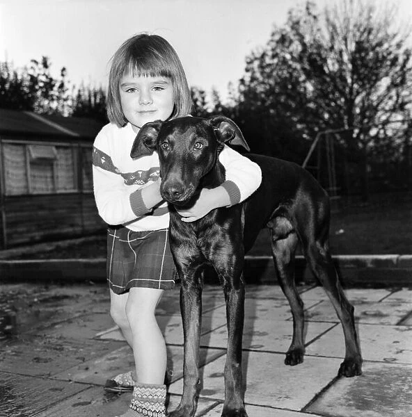 Children with animals. Julie Foster 6, with Jason the dog who was starved by eating only