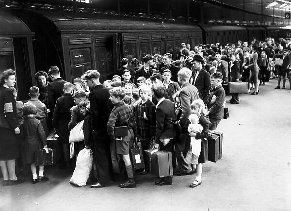Children board a train at Euston Station during evacuation from London WW2