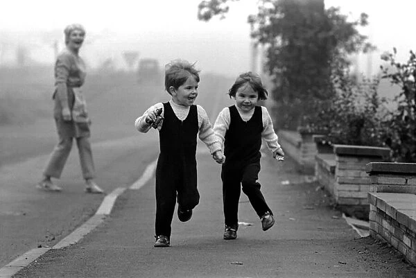 Children: Boy and girl: Young twins holding hands, running with happy expressions