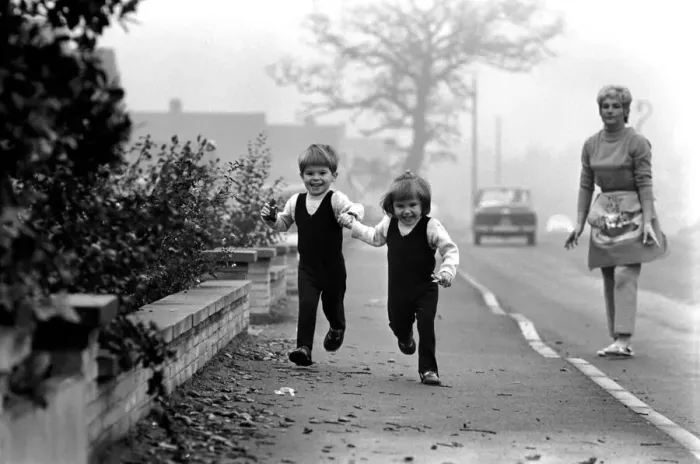 Framed Print : Children: Boy and girl: Young twins holding hands, running with happy expressions