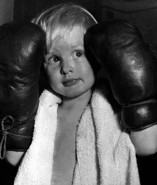 Children - Boys Boxing Young boy wearing boxing gloves, towel around his neck