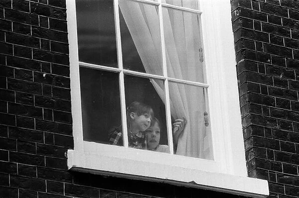 The children of Chancellor of the Exchequer Nigel Lawson watching from a window of 11