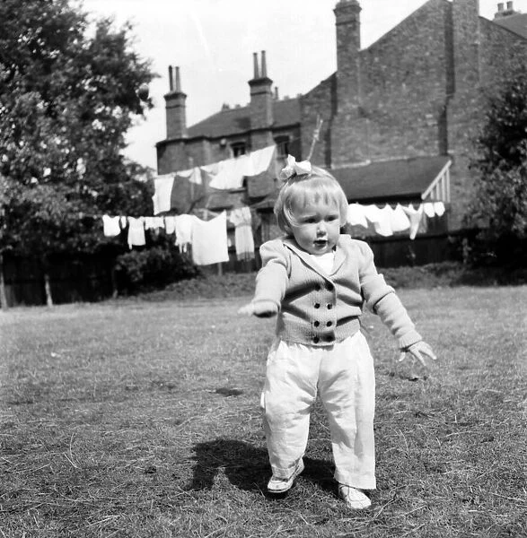 Children child playing in garden. August 1953 D5235-007