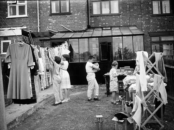 Children clear their bedrooms by having a yard sales in Coventry. Circa 1965
