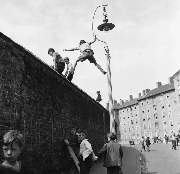 Framed Print : Children climb lamposts and scale high walls to get a better view of the England v