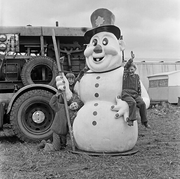 Children climbing on large snowman figure at Silcocks Fair at Skelmersdale 17th May 1973