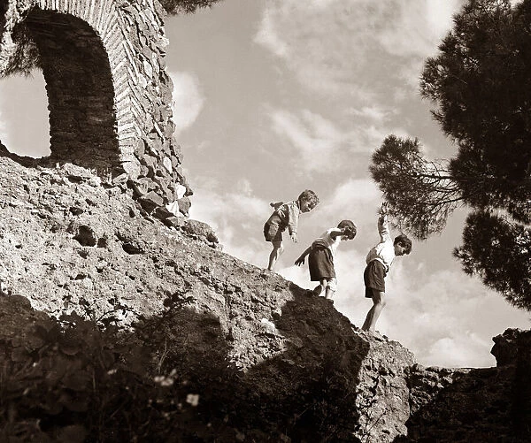 Children climbing amongst the ruins of a castle circa 1950 childhood holidays