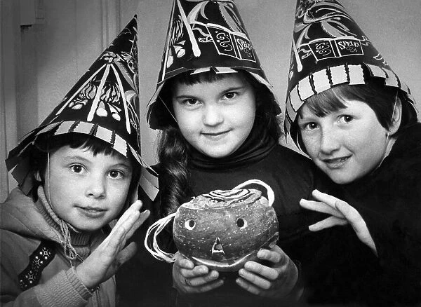 Three children in costume with a turnip lantern for Halloween in October 1979