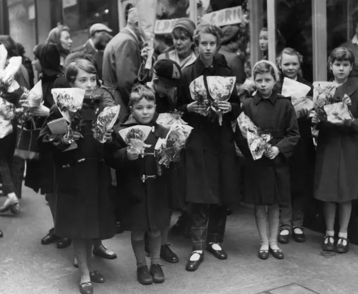Framed Print : Children crowd outside a florists after buying thier flower for Mothering Sunday