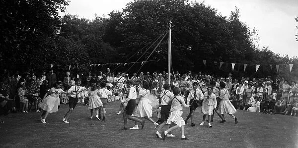 Children dancing around the May Pole in a Coventry Suburb circa 1960