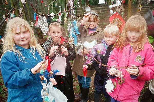 Children decorating trees with christmas decorations in Hancocks Wood, Loftus