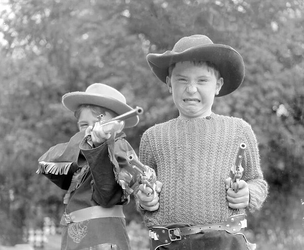 Children dressed & playing Cowboys 29th August 1956. Local Caption Cowboys