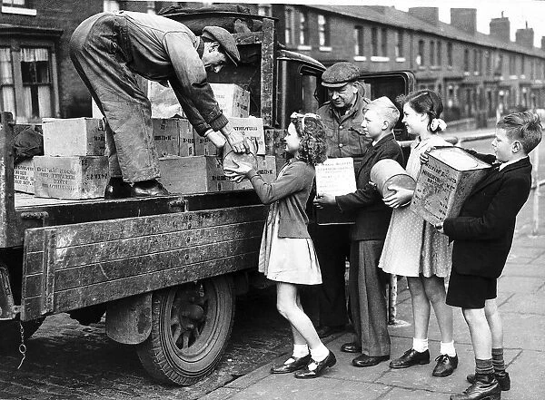 Children in England help load a lorry with food for the troops in Europe 1945 WW2