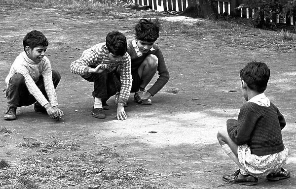 Children enjoy a game of marbles in Hillfields, Coventry. 17th August 1962
