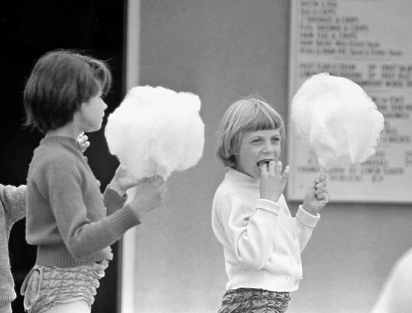 Children enjoying candyfloss from a stall on the seafront at Brighton July 1958