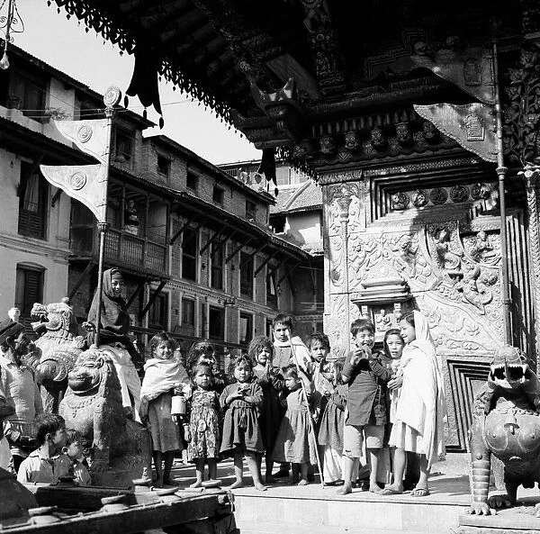 Children gather at a buddhist temple belived to be Changnarayan, Katmandu, Nepal l l