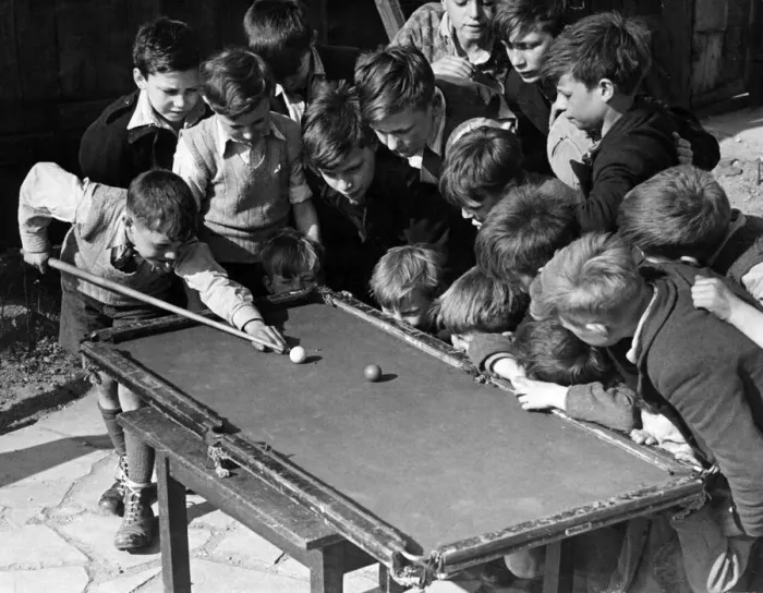 Framed Print : Children gather around a snooker table to play. Sixteen tousled heads bend over a rickety Framed Print : Children gather around a snooker table to play. Sixteen tousled heads bend over a rickety