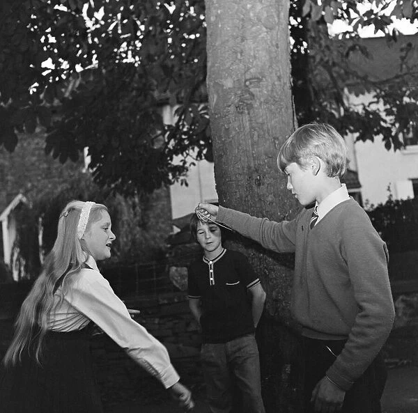 Children in Hartburn, County Durham, playing conkers under a conker tree. 1971