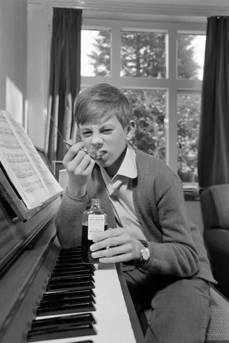 Framed Print : Children. Humour: Young boy at home setting at the piano. November 1969 Z11493-003