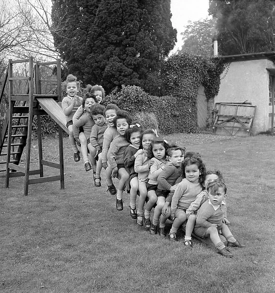 Children Line up on a slide. Circa 1949