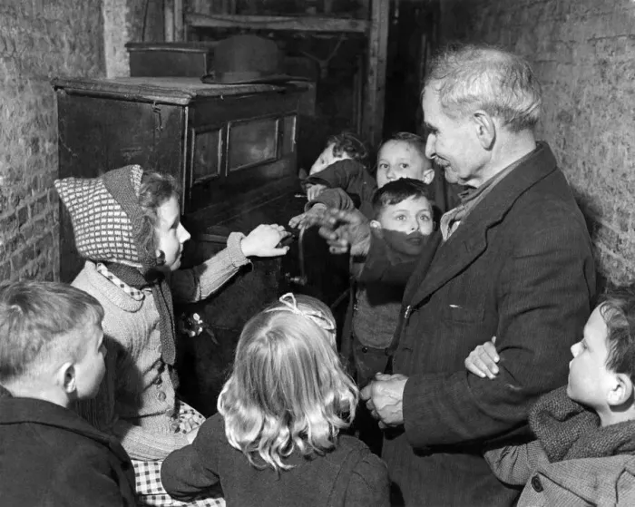 Framed Print : Children listen to a barrel organ being played. February 1944 P004919