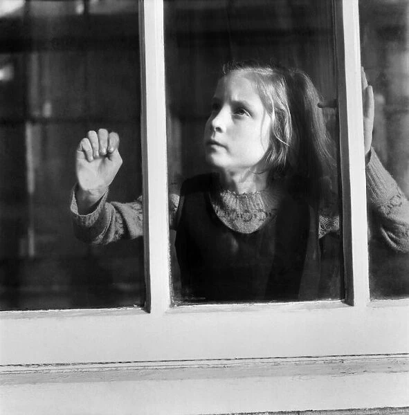 Children. Orphan girl looking out of window. December 1953 D7311-001