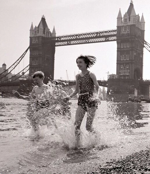 Children paddling on the foreshore below Tower Bridge July 1959
