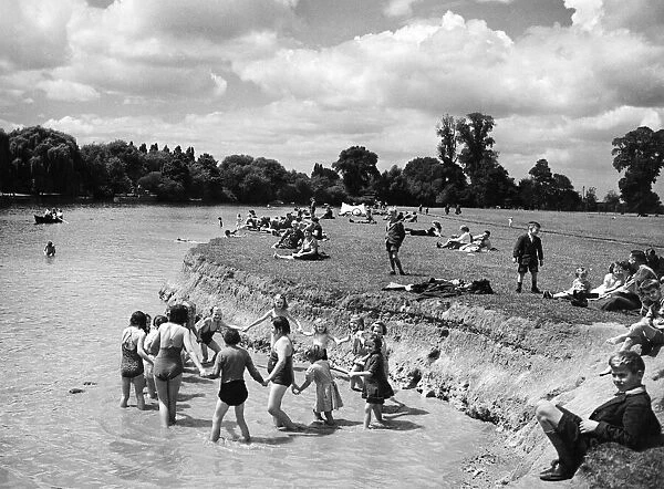 Children paddling in the River Thames at Eton opposite Windsor, Berkshire
