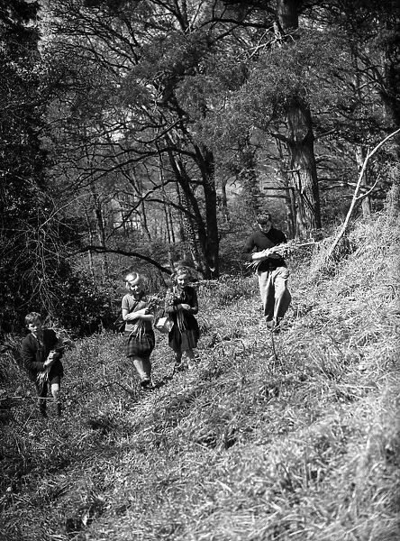 Children picking flowers in the woods. Circa 1940