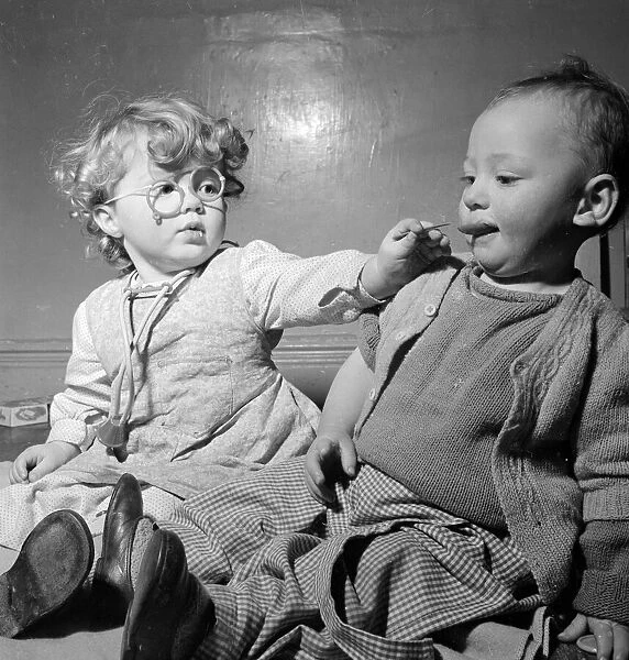 Two children play doctors and nurses at a Bristol Day Nursery December 1952