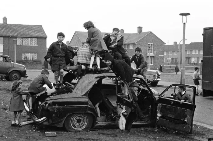Framed Print : Children play on the wreck of a dumped car at Kirkby, Liverpool. 18th March 1965 Framed Print : Children play on the wreck of a dumped car at Kirkby, Liverpool. 18th March 1965