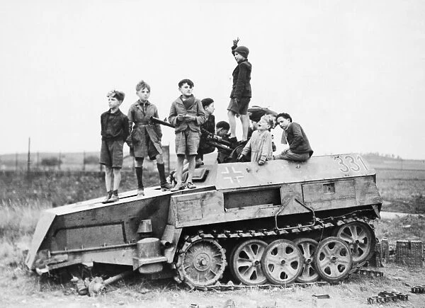 Children playing on armoured Nazi vehicle during the Second World War