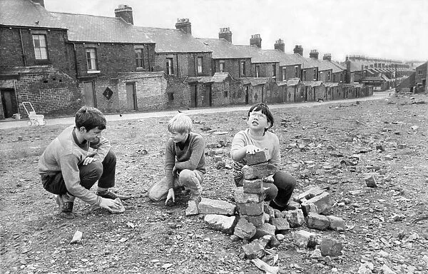 Children playing around demolished houses in Byker, Newcastle