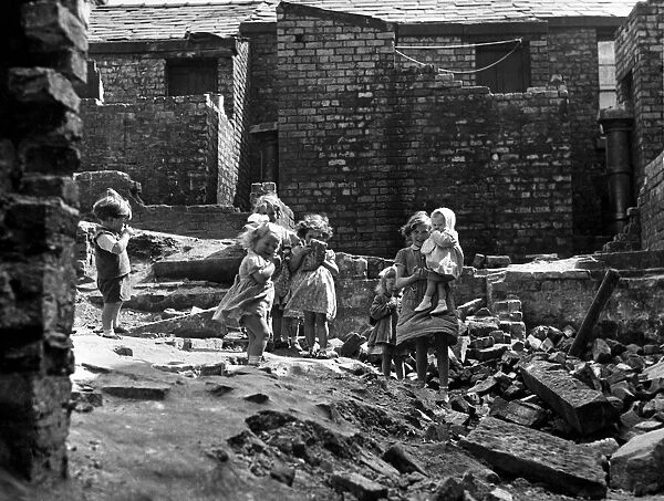 Children playing in a demolished housing area adjacent to their own homes between Sim
