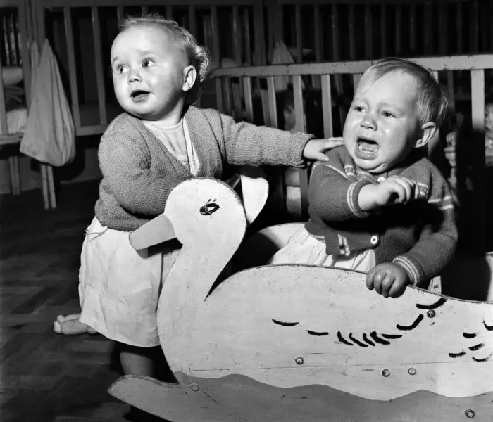 Framed Print : Children playing together with a duck cut out at a day nursery in Leeds November Framed Print : Children playing together with a duck cut out at a day nursery in Leeds November