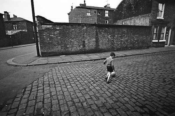 Children playing football in Archie Street, Manchester. Archie Street was the inspiration