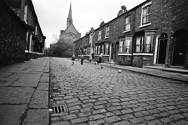Children playing football in Archie Street, Manchester. Archie Street was the inspiration