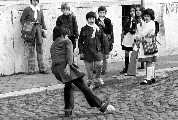 Children playing football on the streets in a poor suburb on the outskirts of Rome