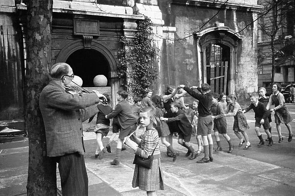 Children playing Oranges and Lemons in the Church of St Clement Danes London. Circa 1946