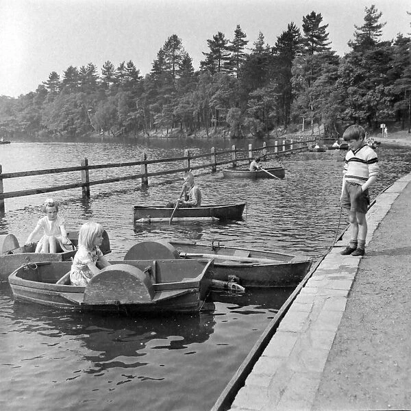 Children playing on paddle boats in Sutton Park