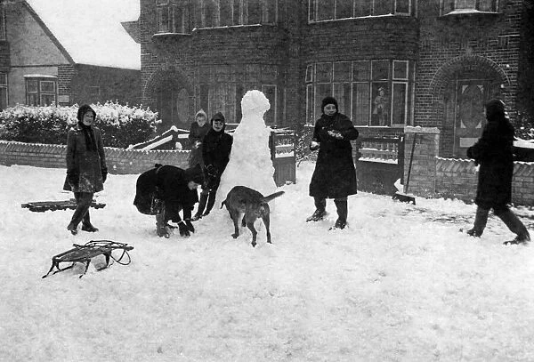 Children playing in the snow, Surrey. Circa 1925. Tyrell Collection