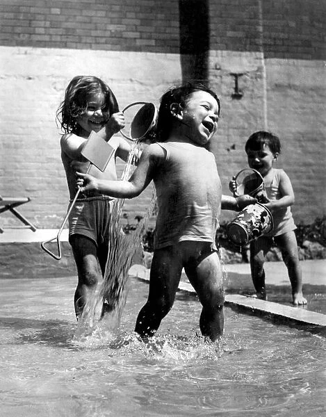 Children playing at a swimming pool in Endell St. London. 7th May 1947